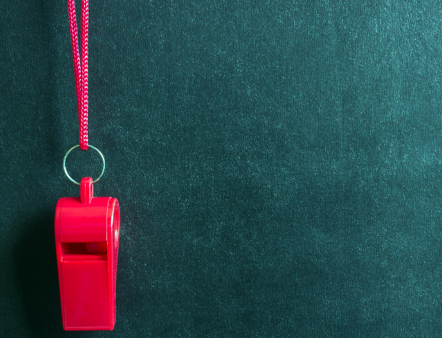 red whistle on solid background