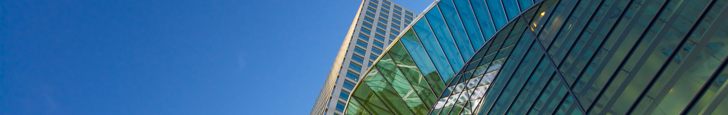 close up of two office building on clear sky