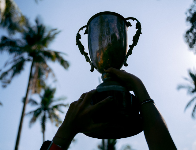 cropped hand of athlete holding a trophy in the air