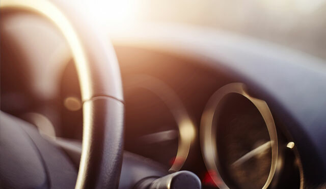 car interior -- close up of steering wheel, shift lever, and dashboard